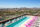 A swimming pool with poolside seating