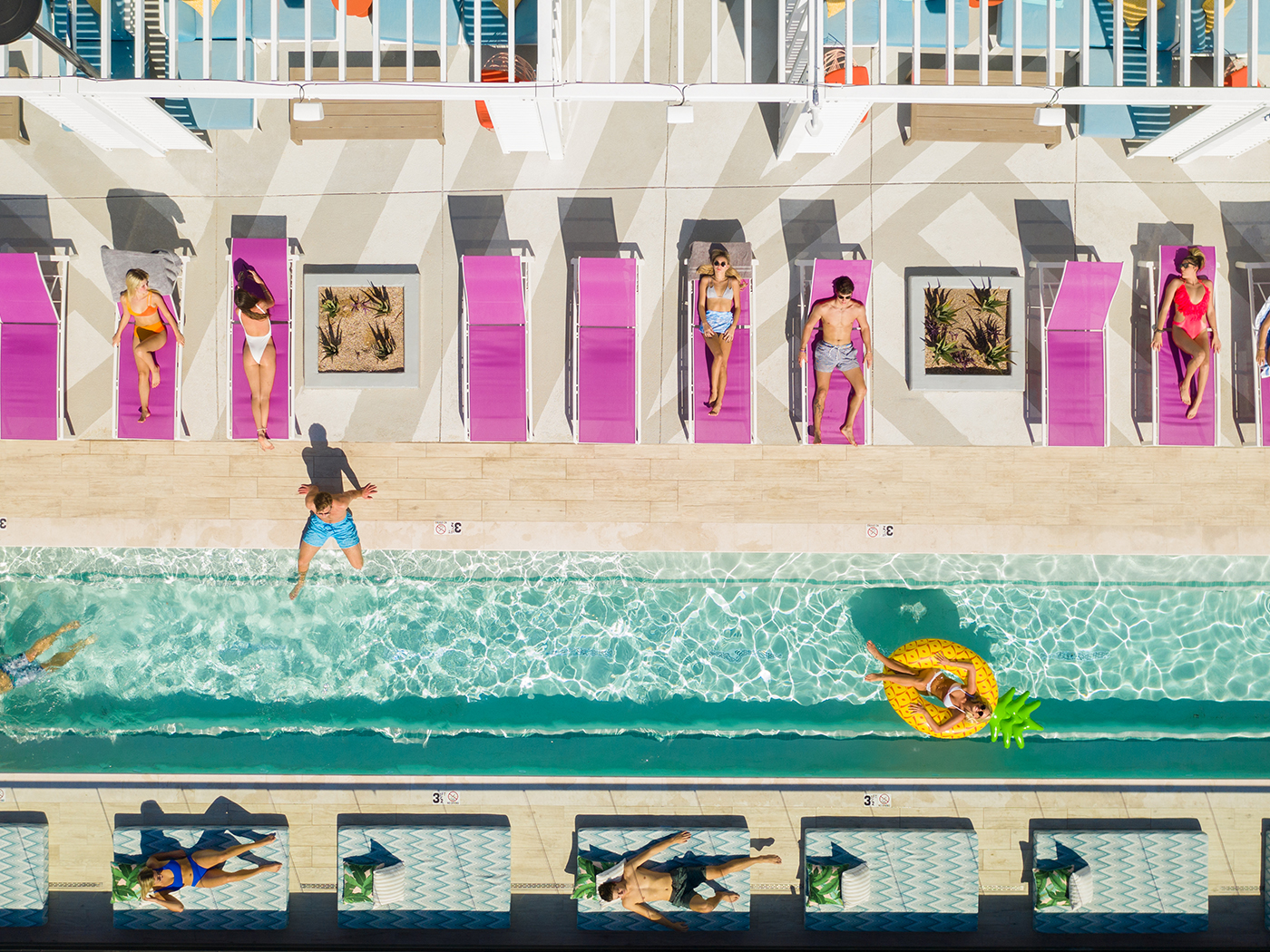 Aerial view of a pool and lounge chairs