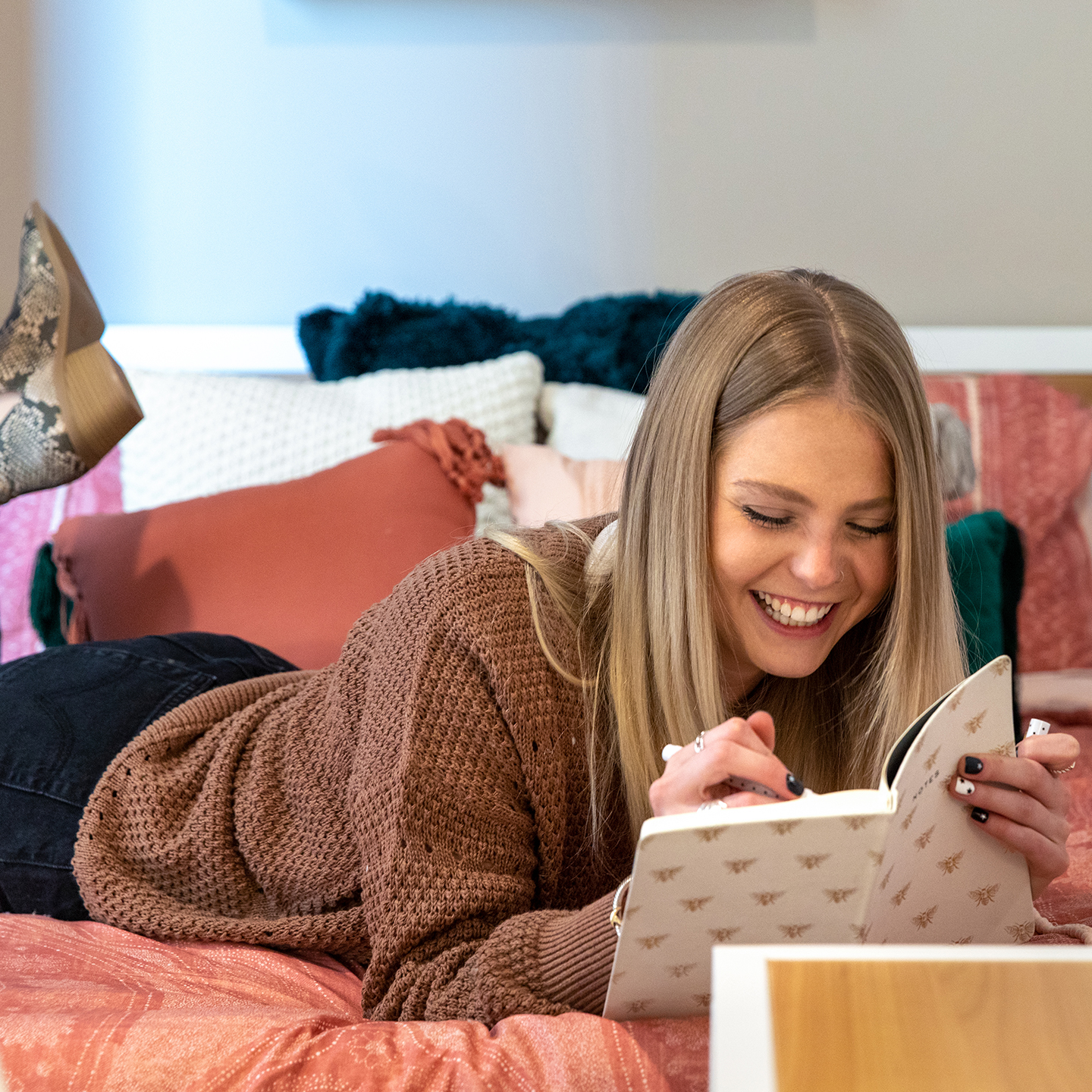 A woman writing in her bed