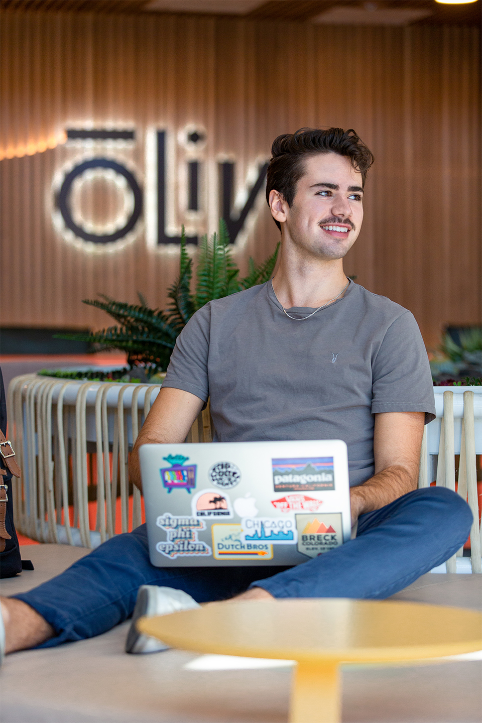 A man sitting and using his laptop